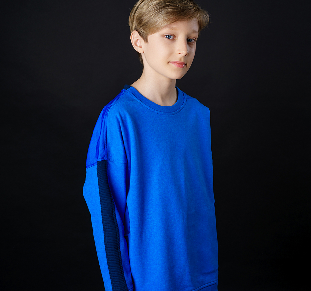 young-guy-blue-t-shirt-poses-black-background